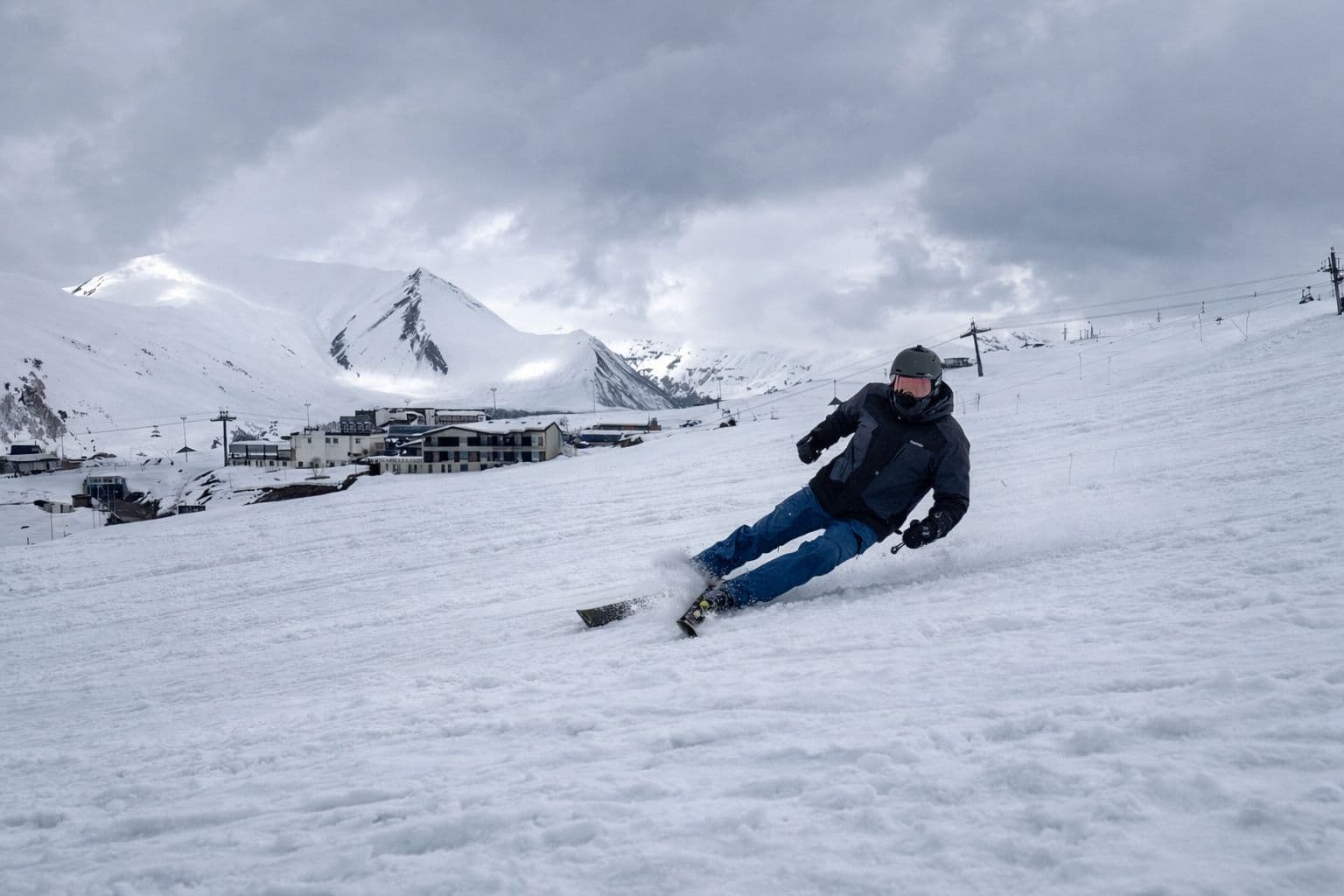 Skier carving across a snow-covered slope in Georgia