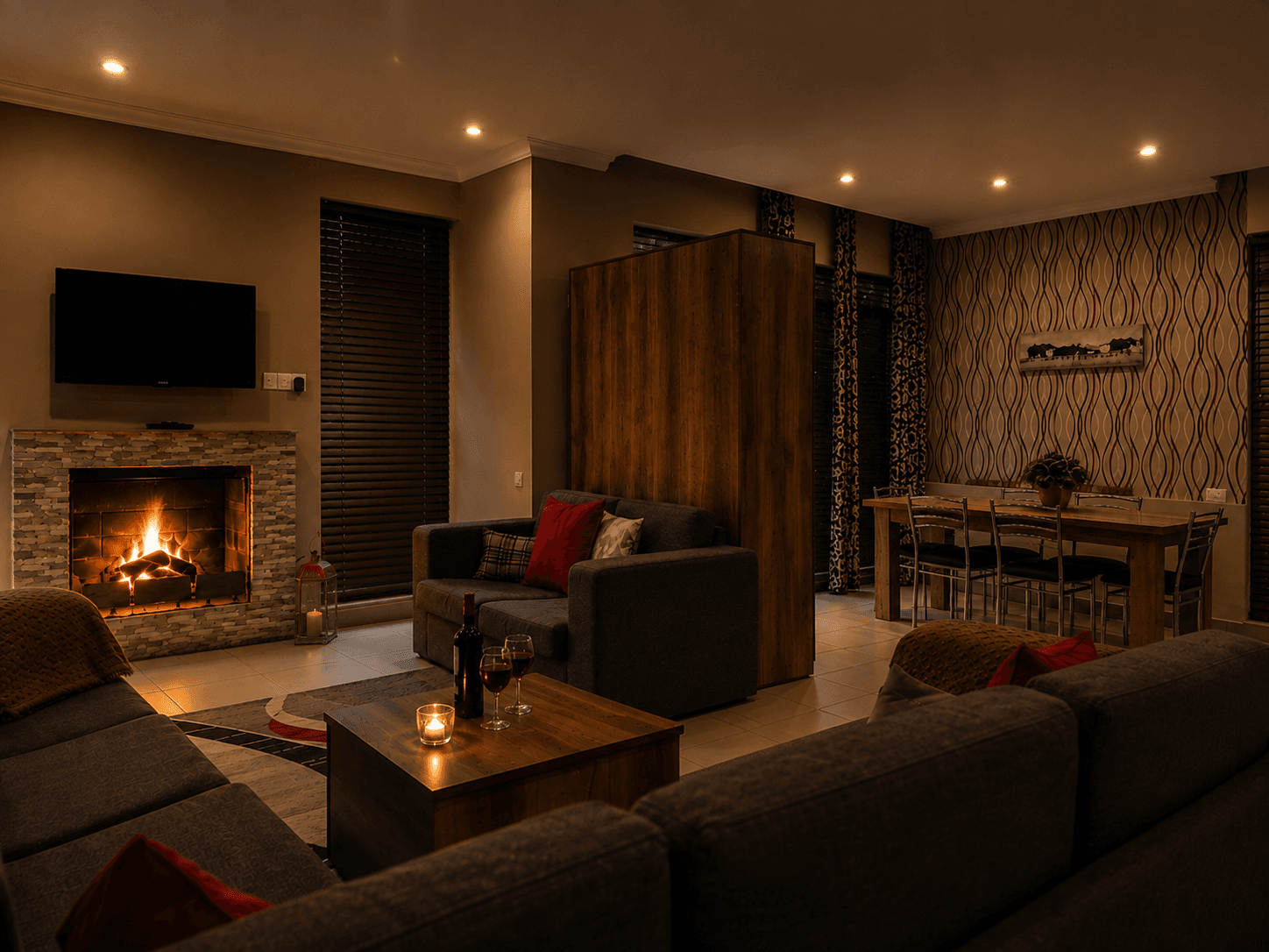 Warm Villa Mtashi living room with fireplace and dining table
