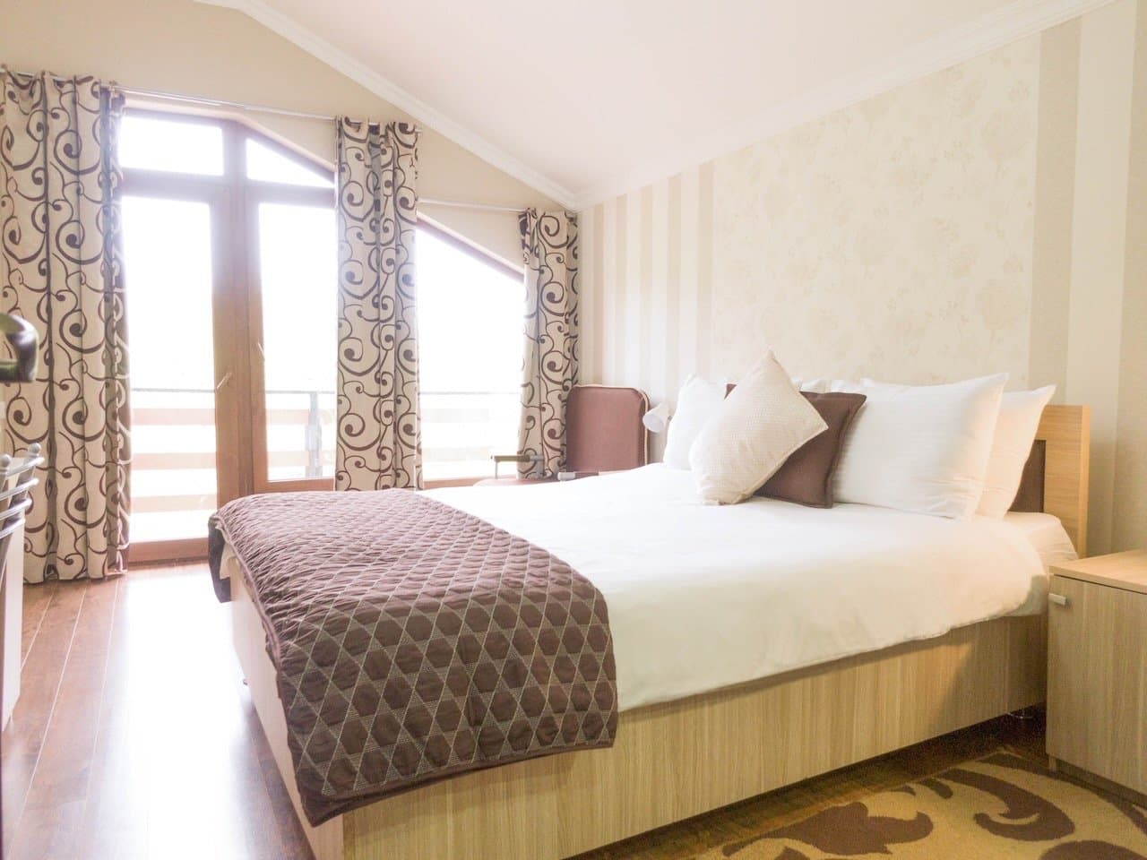 Bright double bedroom in mountain accommodation.