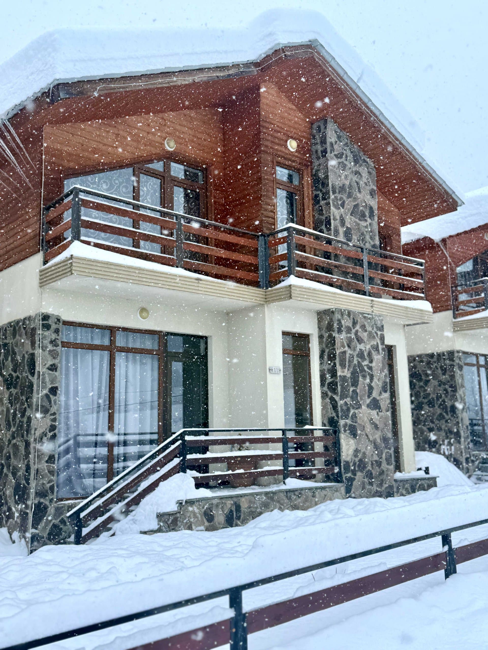 Chalet-style mountain villa in winter snow.