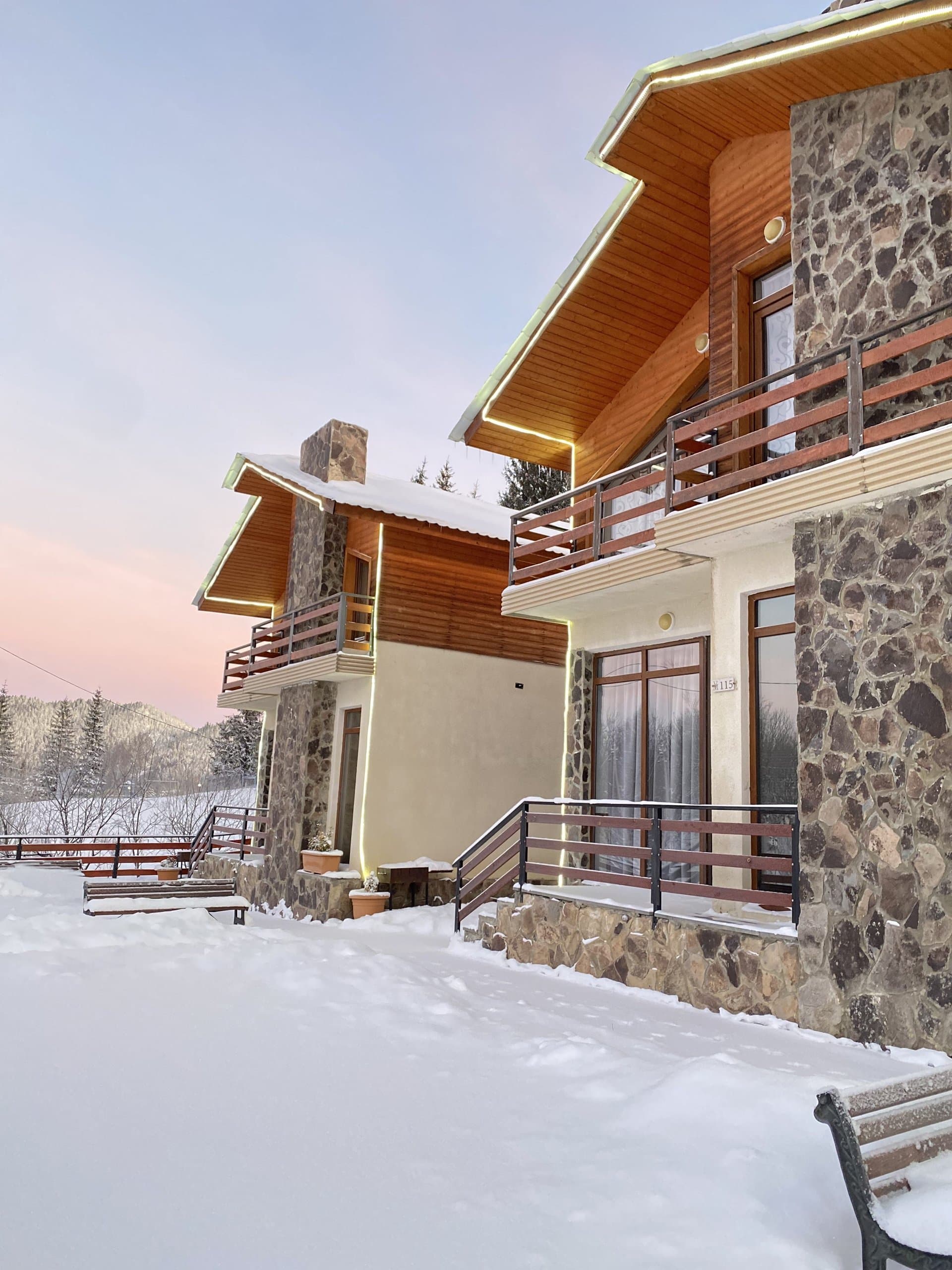 Mountain villa surrounded by fresh snow in winter.