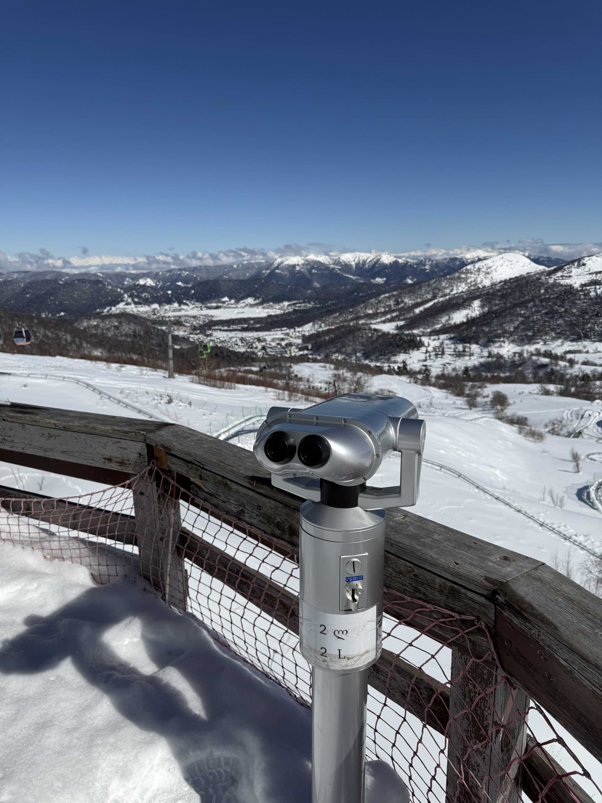 View across snow-covered mountain ridges from a high viewpoint.