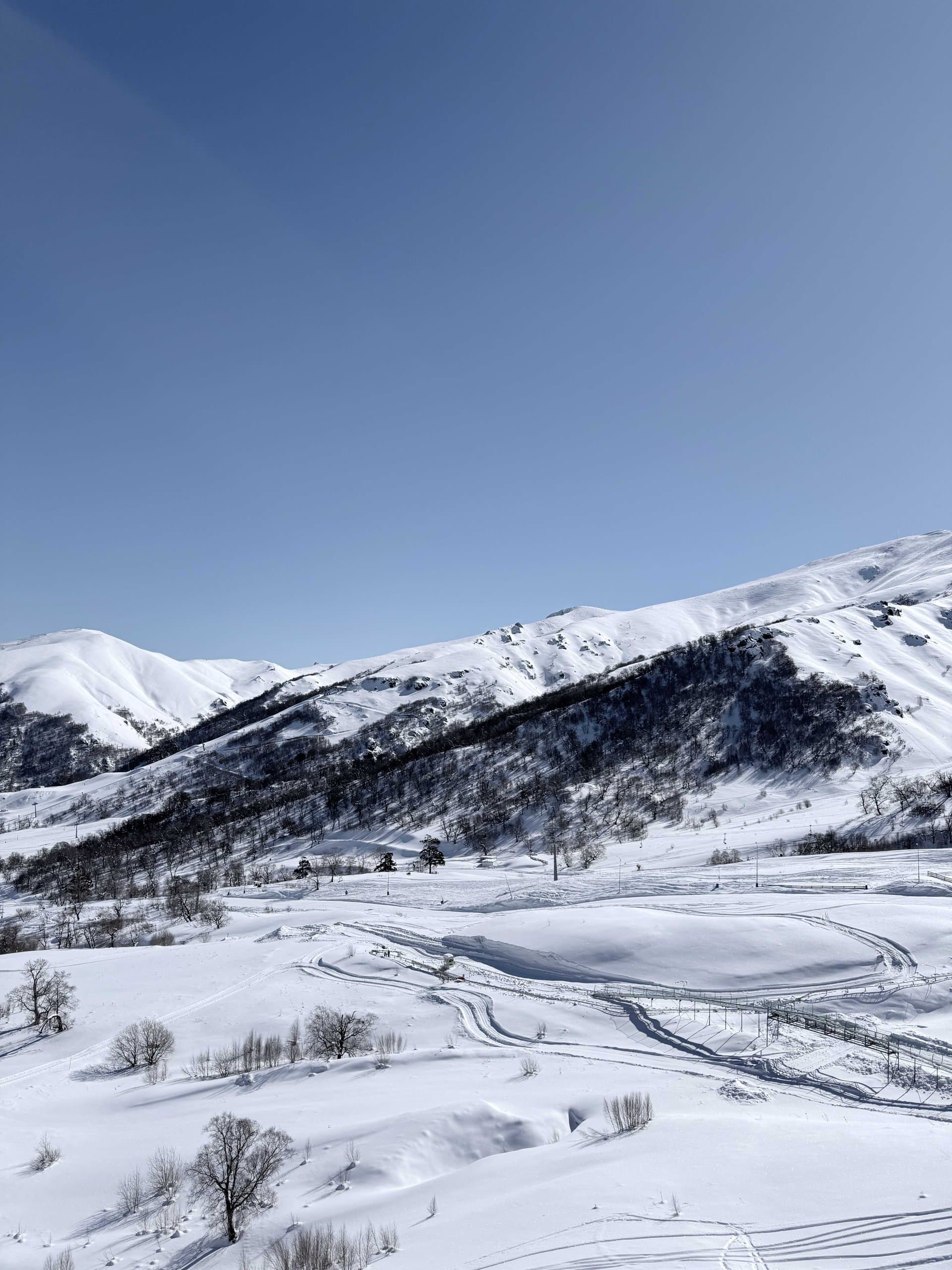 Open ski slopes across a snow-covered mountain.