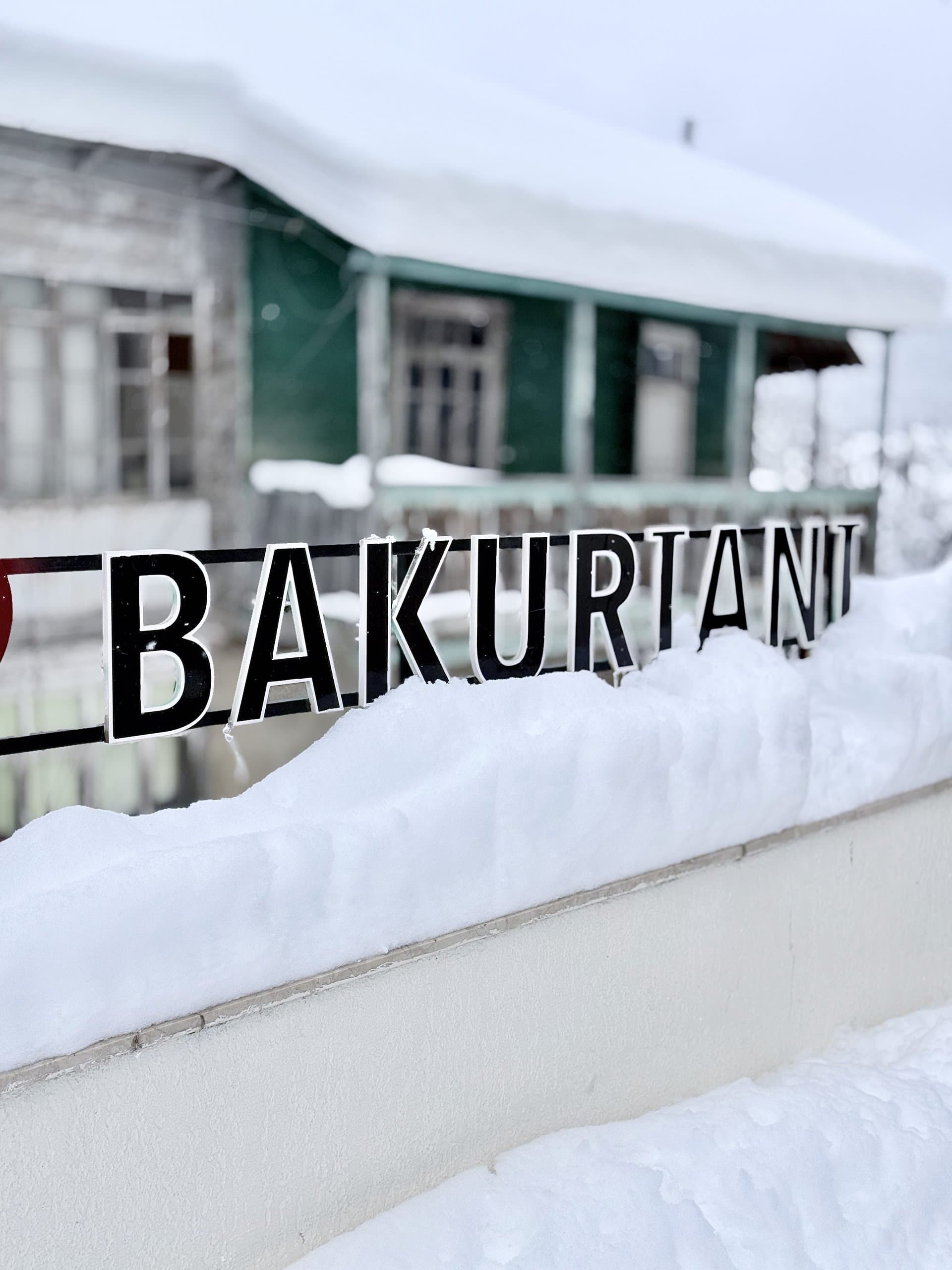Bakuriani sign surrounded by snow in winter.