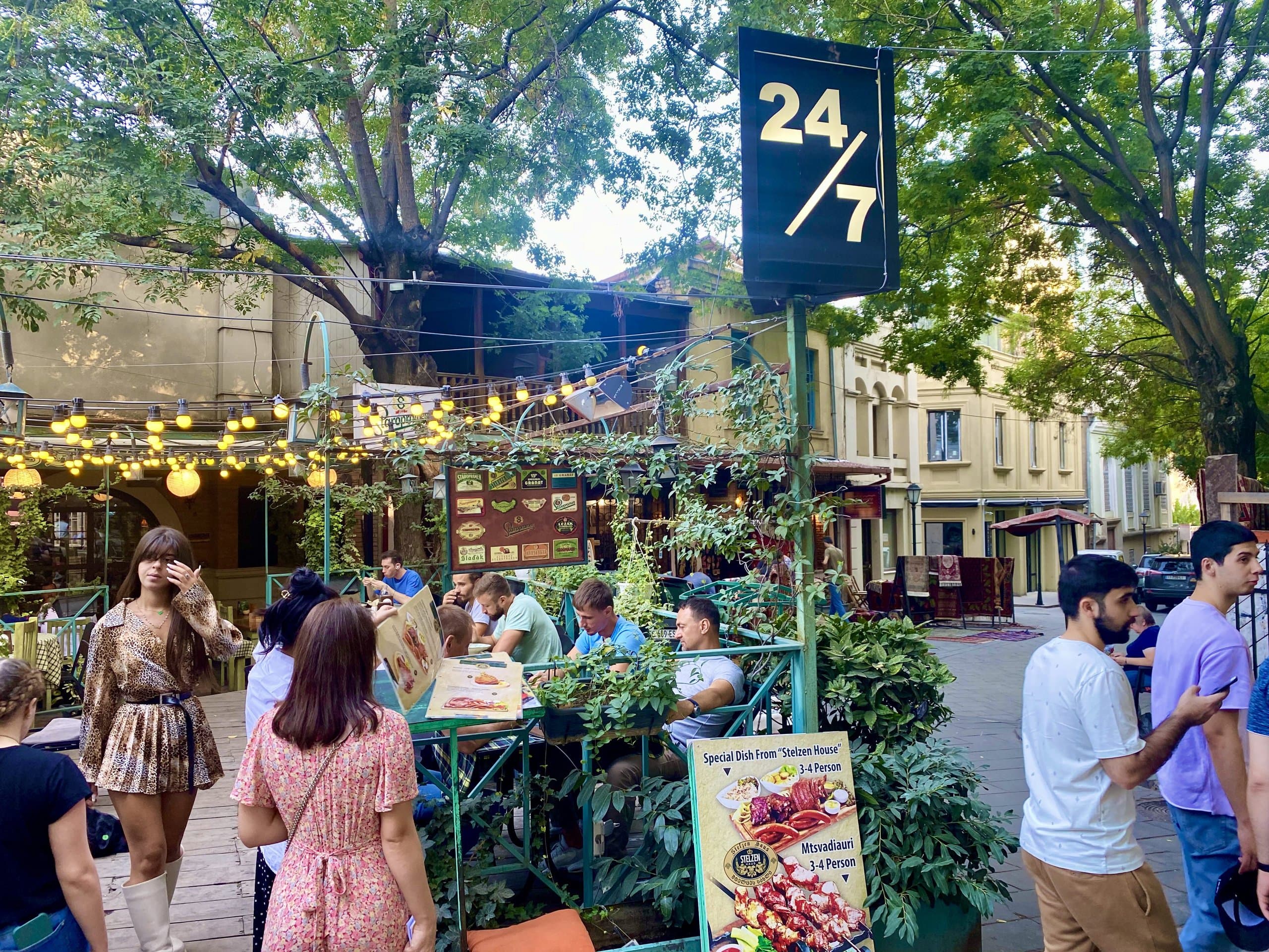 Outdoor café and people enjoying a lively Tbilisi street.