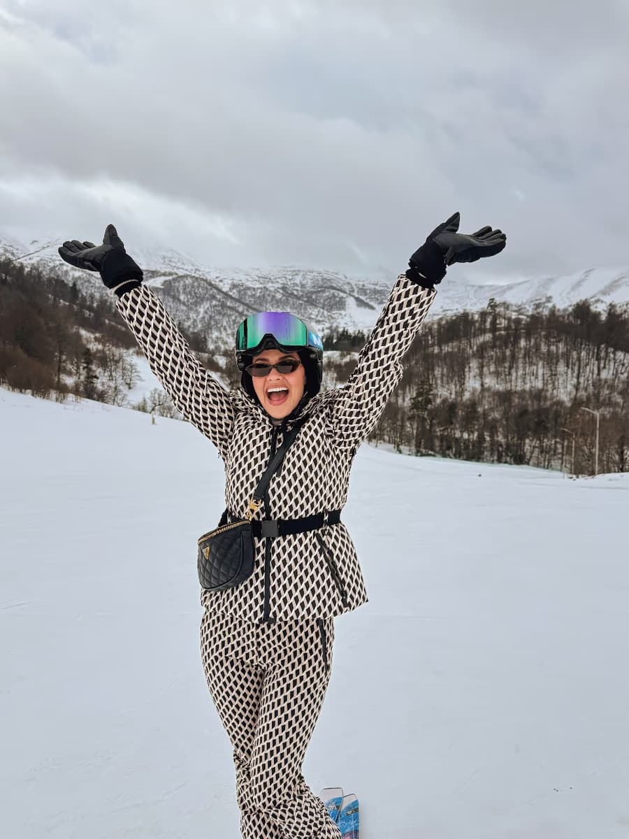 Natasha Joubert skiing on a snowy mountain in Georgia