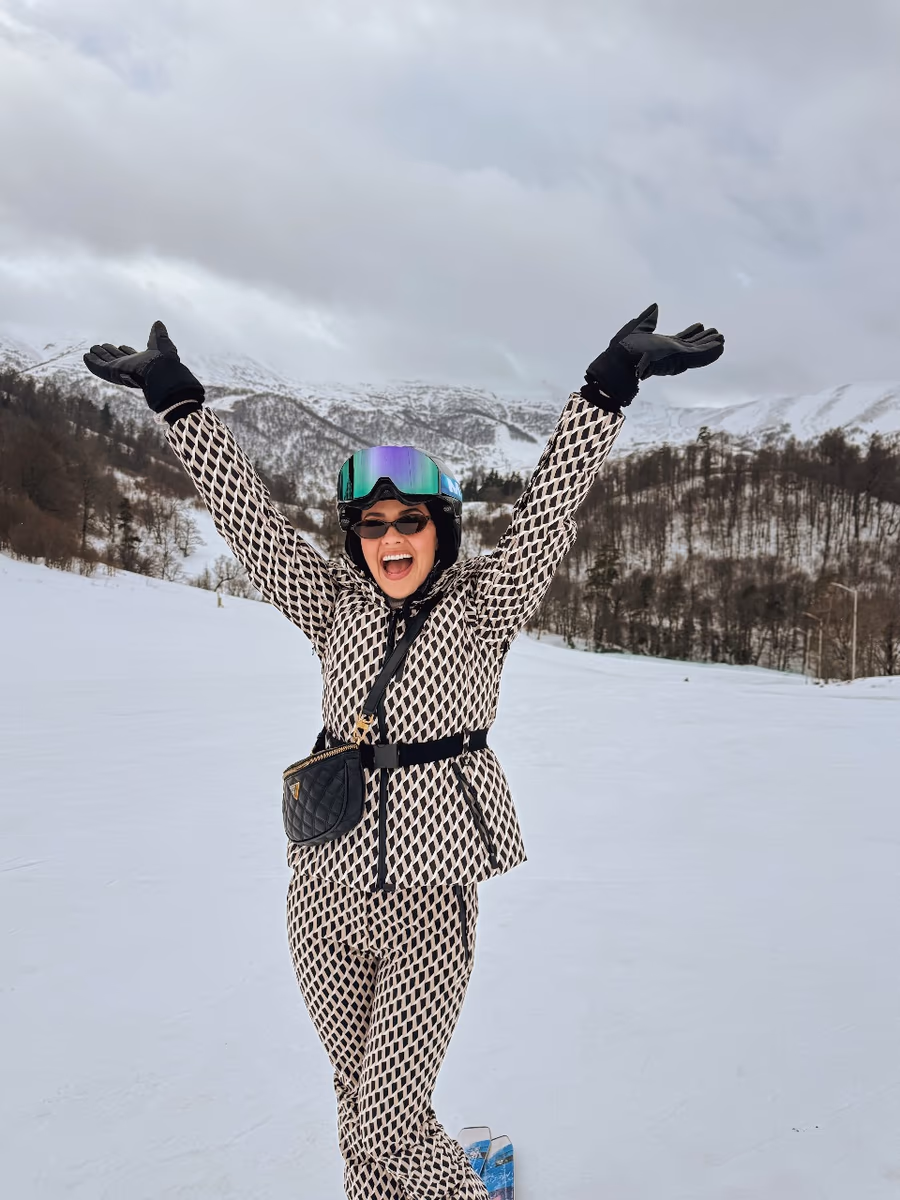 Natasha Joubert skiing on a snowy mountain in Georgia
